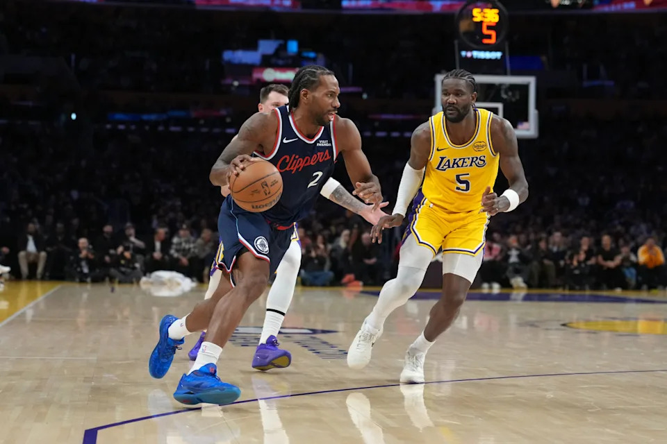 Feb 20, 2026; Los Angeles, California, USA; LA Clippers forward Kawhi Leonard (2) dribbles the ball against Los Angeles Lakers center Deandre Ayton (5) in the second half at Crypto.com Arena. Mandatory Credit: Kirby Lee-Imagn Images