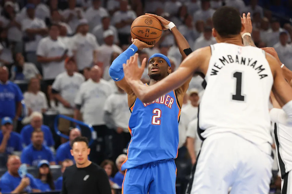 May 20, 2026; Oklahoma City, Oklahoma, USA; Oklahoma City Thunder guard Shai Gilgeous-Alexander (2) shoots as San Antonio Spurs forward Victor Wembanyama (1) defends during the third quarter during game two of the western conference finals for the 2026 NBA playoffs at Paycom Center. Mandatory Credit: Brett Rojo-Imagn Images