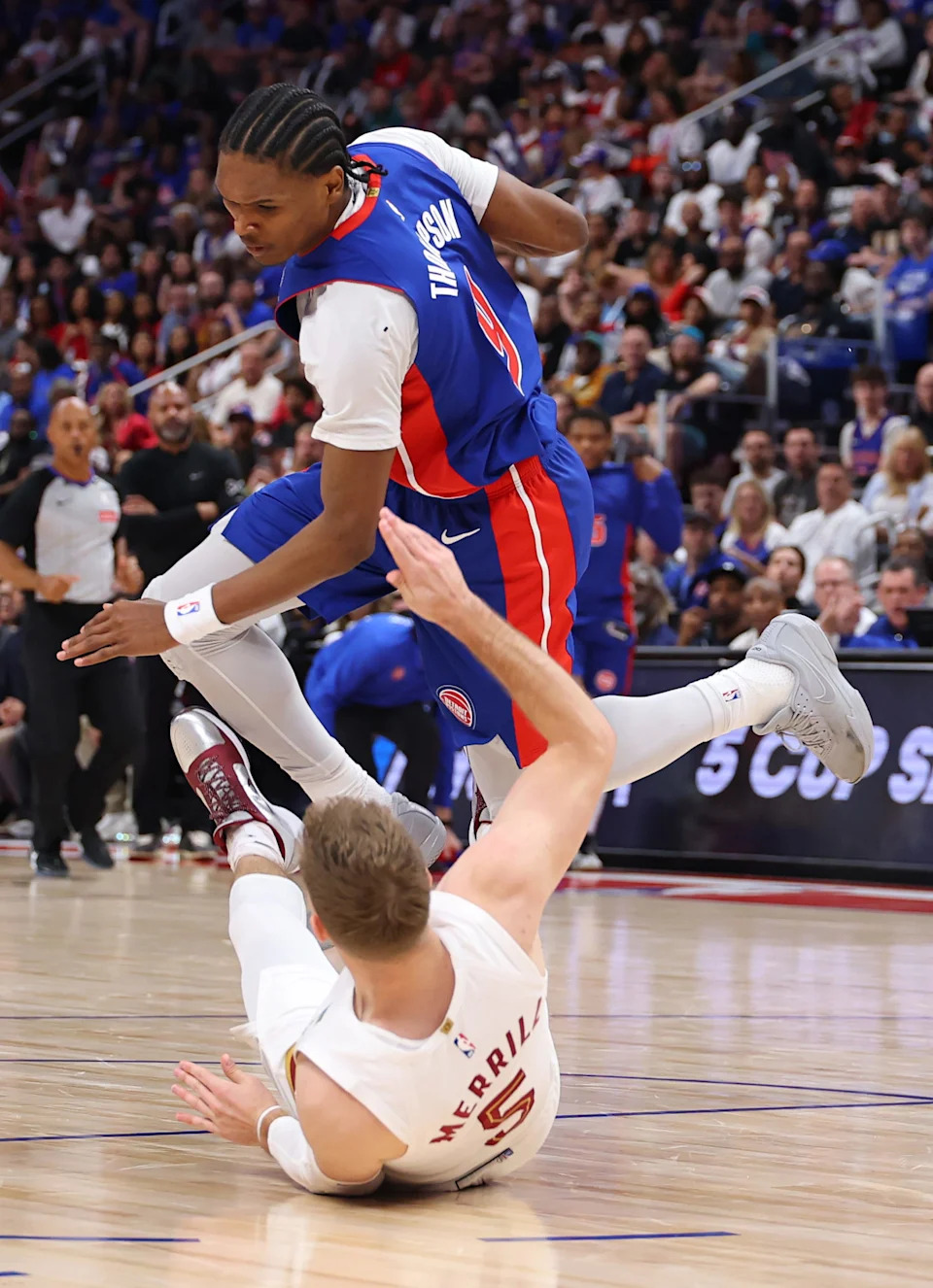Ausar Thompson of the Pistons is called for a charging foul as he knocks down Cavs guard Sam Merrill during the first quarter in Game 7 of the second round of the NBA playoffs, May 17, 2026 in Detroit.