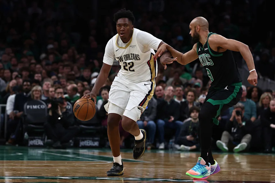 Apr 10, 2026; Boston, Massachusetts, USA; New Orleans Pelicans center Derik Queen (22) tries to get past Boston Celtics guard Derrick White (9) during the second half at TD Garden. Mandatory Credit: Winslow Townson-Imagn Images