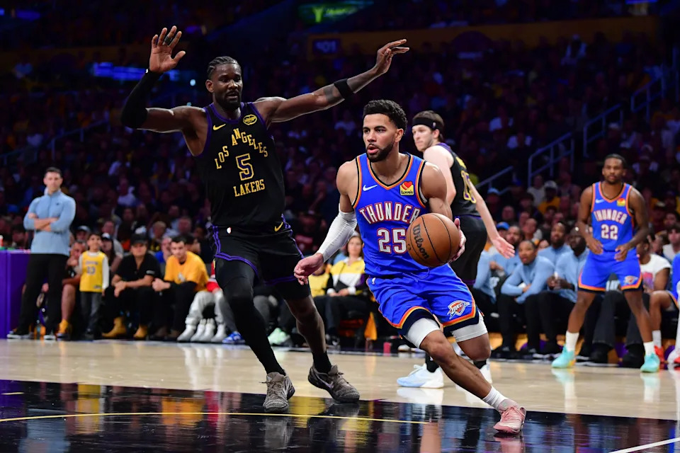May 11, 2026; Los Angeles, California, USA; Oklahoma City Thunder guard Ajay Mitchell (25) moves the ball against Los Angeles Lakers center Deandre Ayton (5) during the second half in game four of the second round of the 2026 NBA Playoffs at Crypto.com Arena. Mandatory Credit: Gary A. Vasquez-Imagn Images