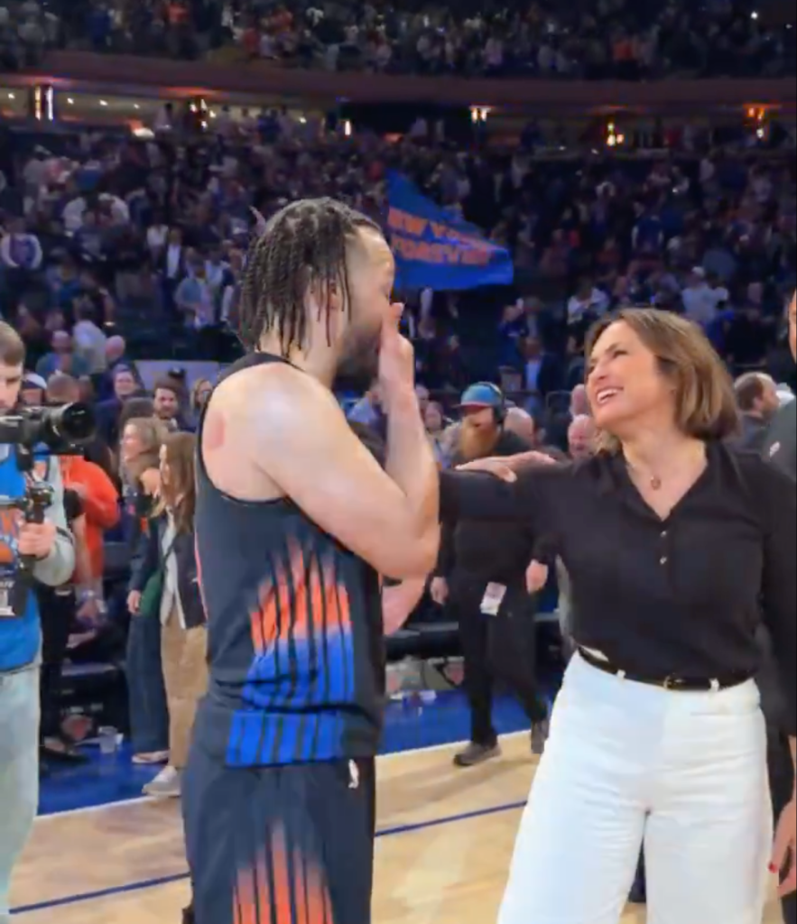 Jalen Brunson with a woman on a basketball court.
