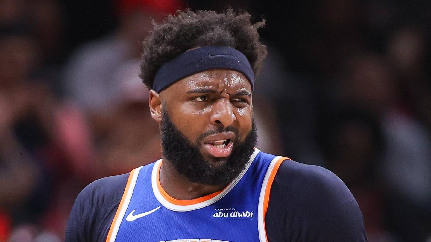 New York Knicks center Mitchell Robinson (23) is restrained by assistant coach Rick Brunson against the Atlanta Hawks in the 2026 NBA Playoffs at State Farm Arena on April 30, 2026.