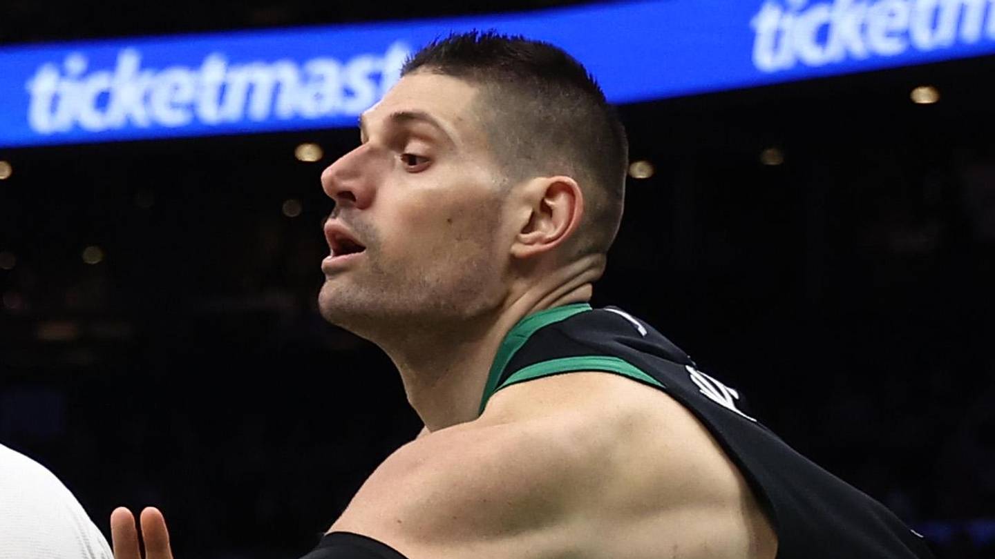 Apr 10, 2026; Boston, Massachusetts, USA; Boston Celtics center Nikola Vucevic (4) tries to knock the ball away from New Orleans Pelicans center Derik Queen (22) during the second half at TD Garden. Mandatory Credit: Winslow Townson-Imagn Images