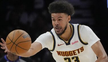 Apr 23, 2026; Minneapolis, Minnesota, USA; Denver Nuggets forward Cameron Johnson (23) goes after the ball against the Minnesota Timberwolves in the third quarter at Target Center. Mandatory Credit: Bruce Kluckhohn-Imagn Images