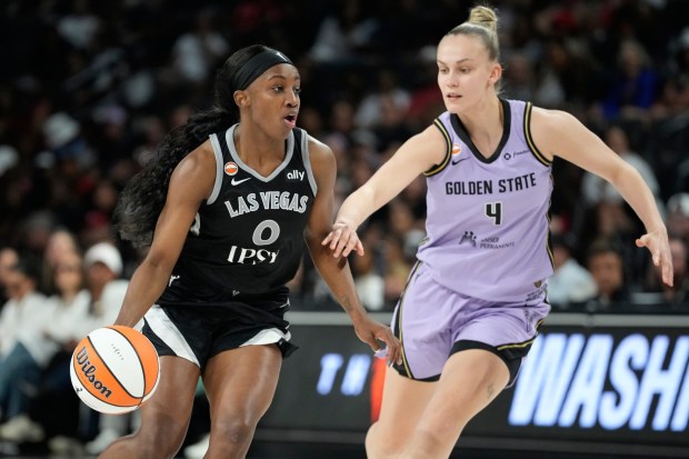 Las Vegas Aces guard Jackie Young (0) drives against Golden State Valkyries guard Juste Jocyte (4) during the second half of a WNBA basketball game Sunday, June 21, 2026, in Las Vegas. (AP Photo/John Locher)