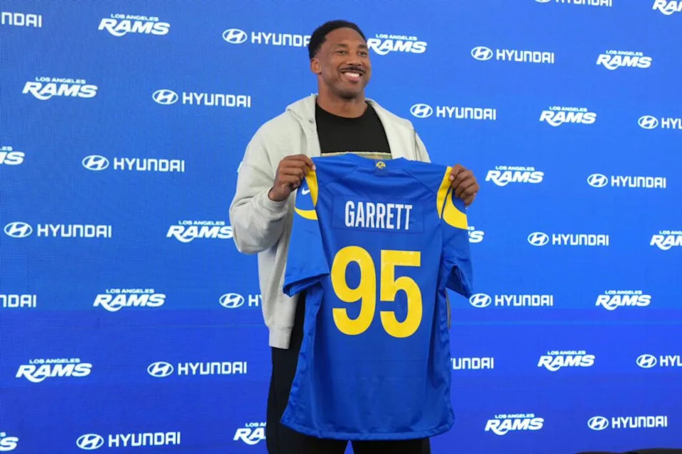 Los Angeles Rams defensive end Myles Garrett (95) poses with jersey at press conference at Rams Practice Facility. Mandatory Credit: Kirby Lee-Imagn Images