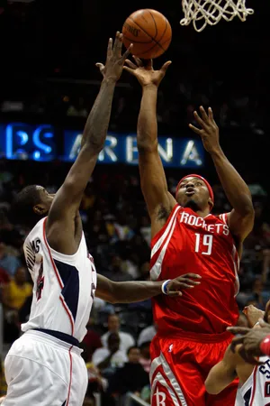 ATLANTA - MARCH 12: Mike Harris #19 of the Houston Rockets makes a shot over Marvin Williams #24 of the Atlanta Hawks on March 12, 2008 at the Philips Arena in Atlanta, Georgia. NOTE TO USER: User expressly acknowledges and agrees that, by downloading and/or using this Photograph, user is consenting to the terms and conditions of the Getty Images License Agreement. (Photo by Chris Graythen/Getty Images)