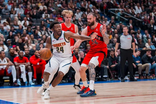 Oct 6, 2025; Vancouver, British Columbia, CAN; Denver Nuggets guard Jalen Pickett (24) drives away from Toronto Raptors forward Gradey Dick (1) and forward Sandro Mamukelashvili (54) in the first half at Rogers Arena. Mandatory Credit: Bob Frid-Imagn Images