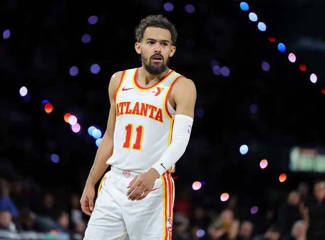 Trae Young #11 of the Atlanta Hawks stands on the court during a break in the second half of a semifinal game of the Emirates NBA Cup against the Milwaukee Bucks.