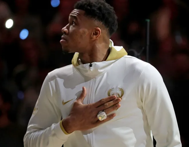 Oct. 19, 2021; Milwaukee, WI, USA; Milwaukee Bucks forward Giannis Antetokounmpo (34) watches as the the Milwaukee Bucks' 2021 championship banner is unveiled with his Championship ring during Milwaukee Bucks ring ceremony; Mand atory credit: Mike De Sisti-USA TODAY NETWORK via Imagn Images