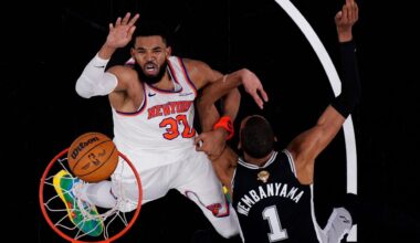New York Knicks center Karl-Anthony Towns (32) shoots past San Antonio Spurs forward Victor Wembanyama (1) during the first half of Game 1 of the NBA Finals basketball series, Wednesday, June 3, 2026, in San Antonio.