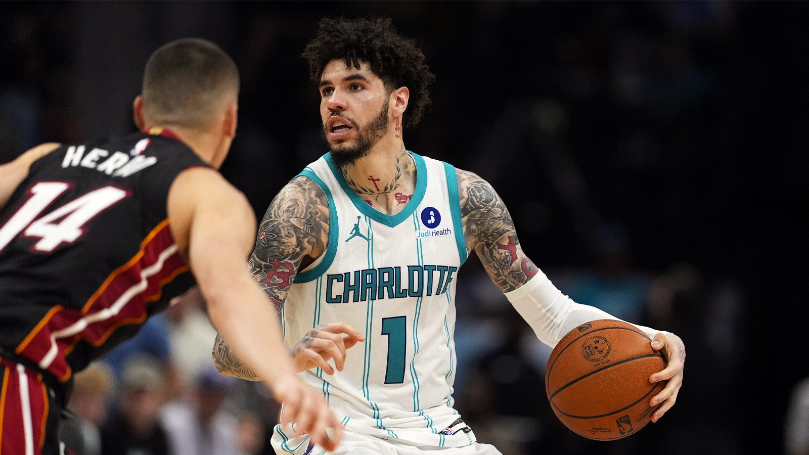 Charlotte Hornets guard LaMelo Ball (1) looks to pass defended by Miami Heat guard Tyler Herro (14) during the second half during the play-in rounds between the Charlotte Hornets and the Miami Heat of the 2026 NBA Playoffs at Spectrum Center.
