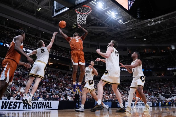 Texas' Dailyn Swain drives to the basket during the first half of a Sweet 16 game against Purdue on March 26, 2026, in San Jose, Calif. (AP Photo/Godofredo A. Vásquez)