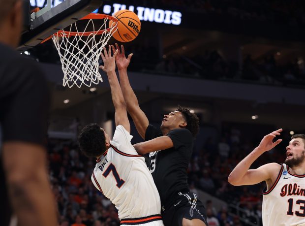 Xavier guard Dailyn Swain drives on Illinois forward Will Riley in the first half of a first-round NCAA Tournament game March 21, 2025, in Milwaukee. (Chris Sweda/Chicago Tribune)