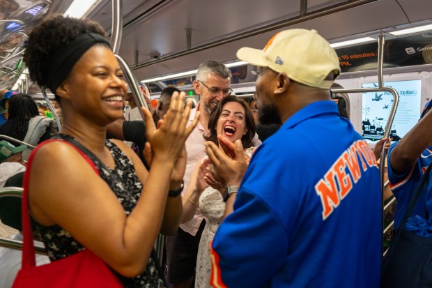 NEW YORK, NEW YORK - JUNE 13: New Yorkers celebrate on an A subway train after the Knicks win Game 5 of the NBA finals to secure the championship on June 13, 2026 in New York City. The Knicks closed out the San Antonio Spurs to win their first title since 1973. (Photo by Jeremy Weine/Getty Images)