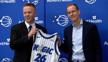 Sean Sweeney (Left) and Magic president of basketball operations Jeff Weltman poising with Sweeney's new 26 jersey. (Nick Allen/Spectrum Sports 360)