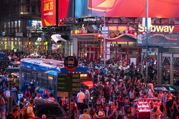 New York Knicks fans celebrate in Times Square after the Knicks defeated the San Antonio Spurs in the NBA Finals on Saturday, June 13, 2026 in Manhattan, New York. (Barry Williams/ New York Daily News)