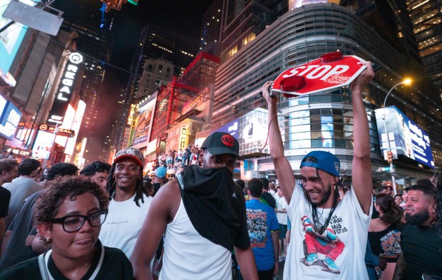 A Knicks fan shows off his trophy from a bus on w42nd St. after the Knicks defeated the Spurs Saturday, June 13, 2026 in Manhattan, New York. (Barry Williams/ New York Daily News)