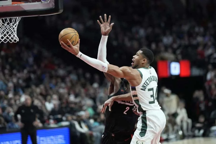 Jan 28, 2025; Portland, Oregon, USA; Milwaukee Bucks power forward Giannis Antetokounmpo (34) shoots the ball against Portland Trail Blazers center Deandre Ayton (2) during the second half at Moda Center. Mandatory Credit: Soobum Im-Imagn Images