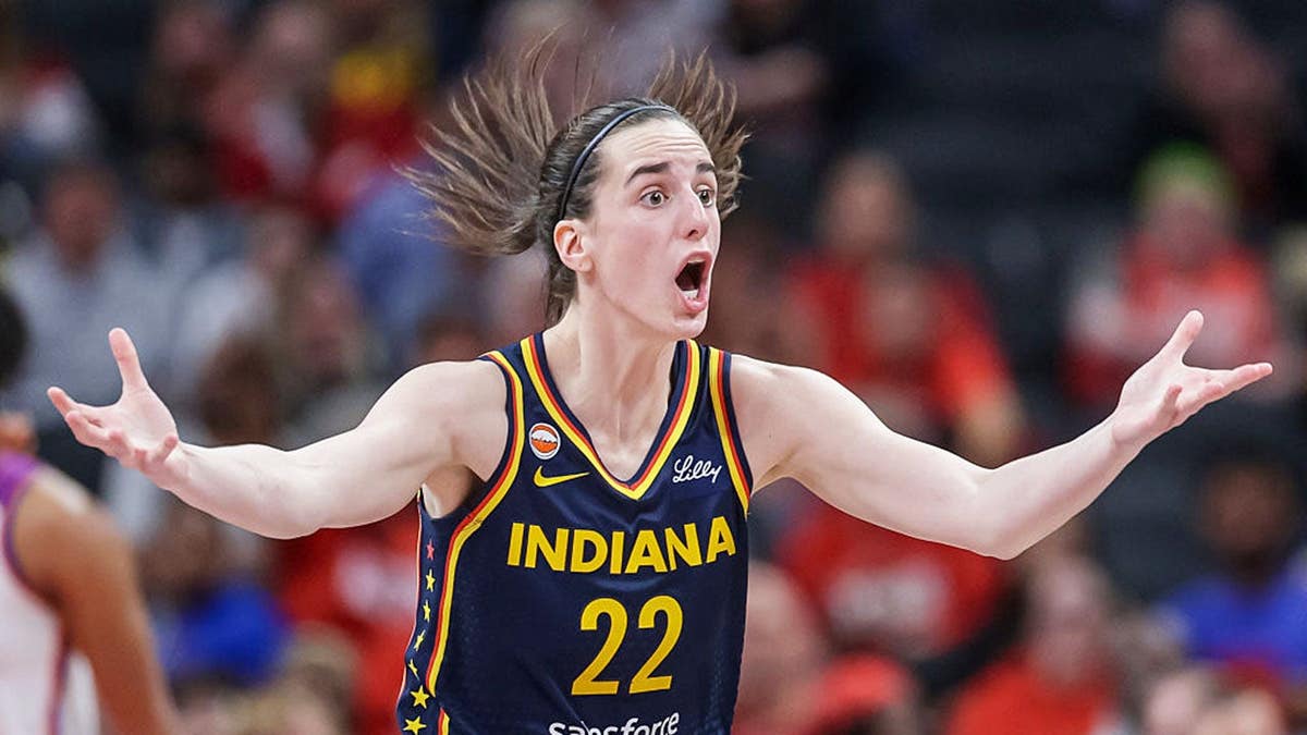 Caitlin Clark wearing number 22 jersey reacting during a basketball game at Gainbridge Fieldhouse.