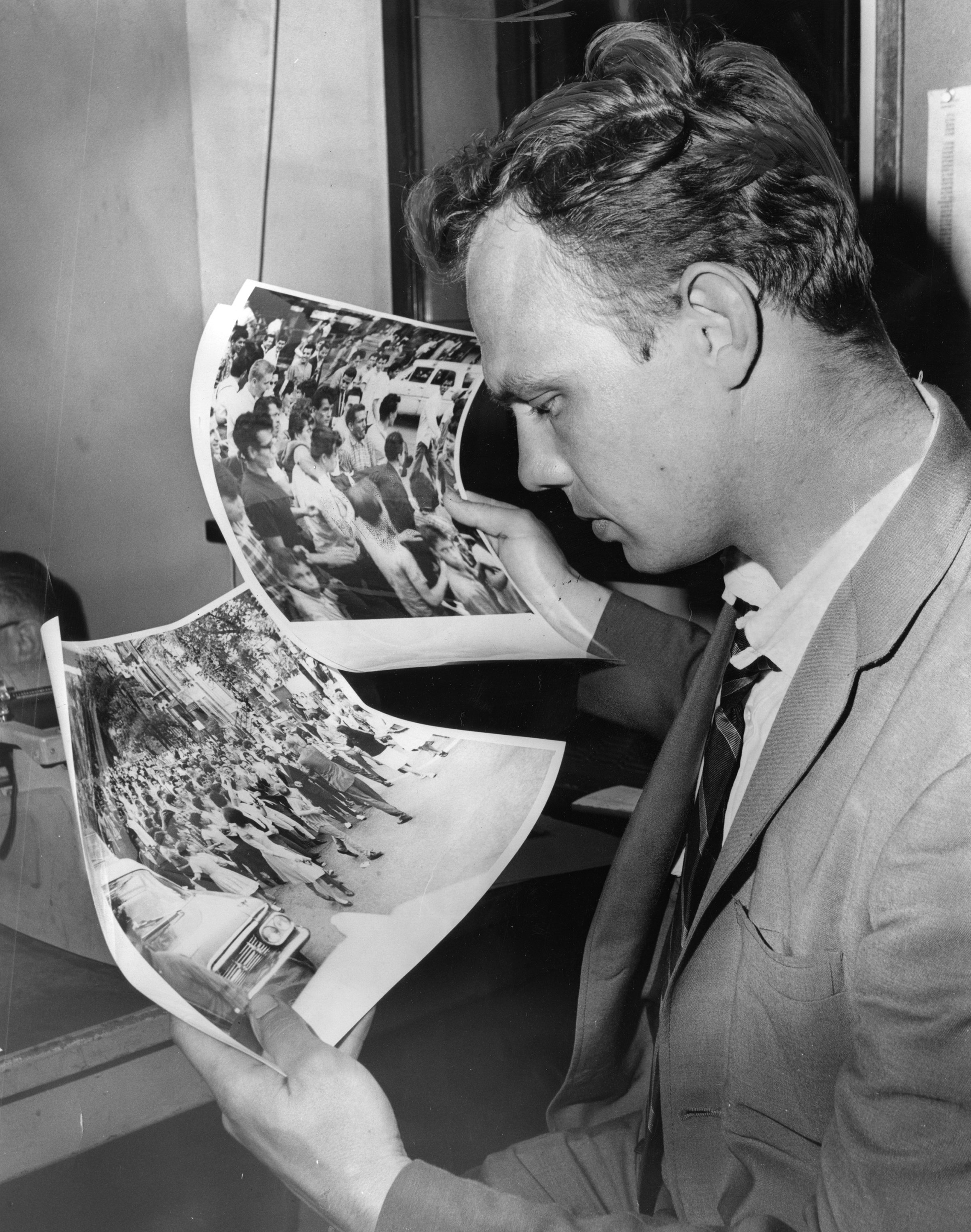 Tribune Photographer Ray Foster checks pictures he took before the...