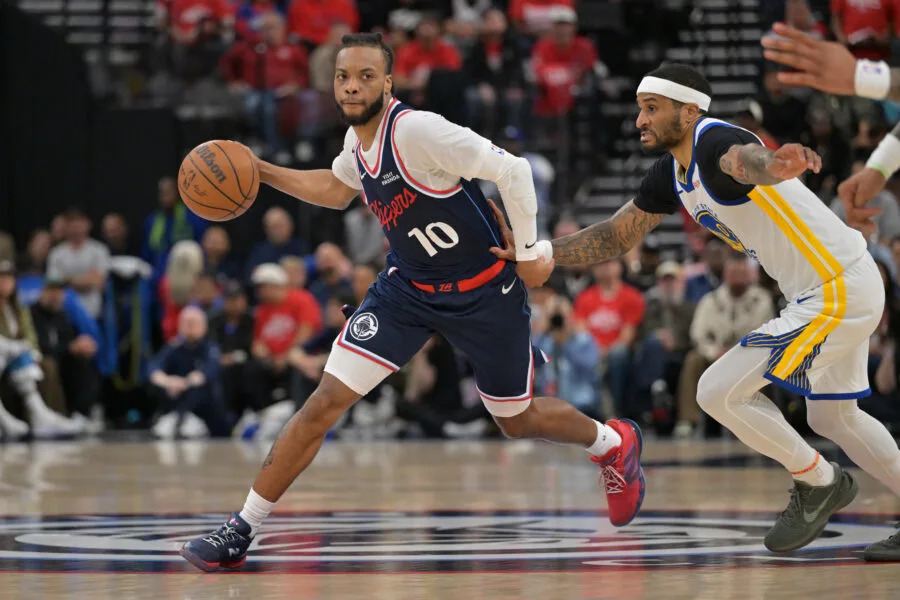 Apr 15, 2026; Inglewood, California, USA; Los Angeles Clippers guard Darius Garland (10) is defended by Golden State Warriors guard Gary Payton II (0) in the first half during the play-in rounds of the 2026 NBA Playoffs at Intuit Dome. Mandatory Credit: Jayne Kamin-Oncea-Imagn Images