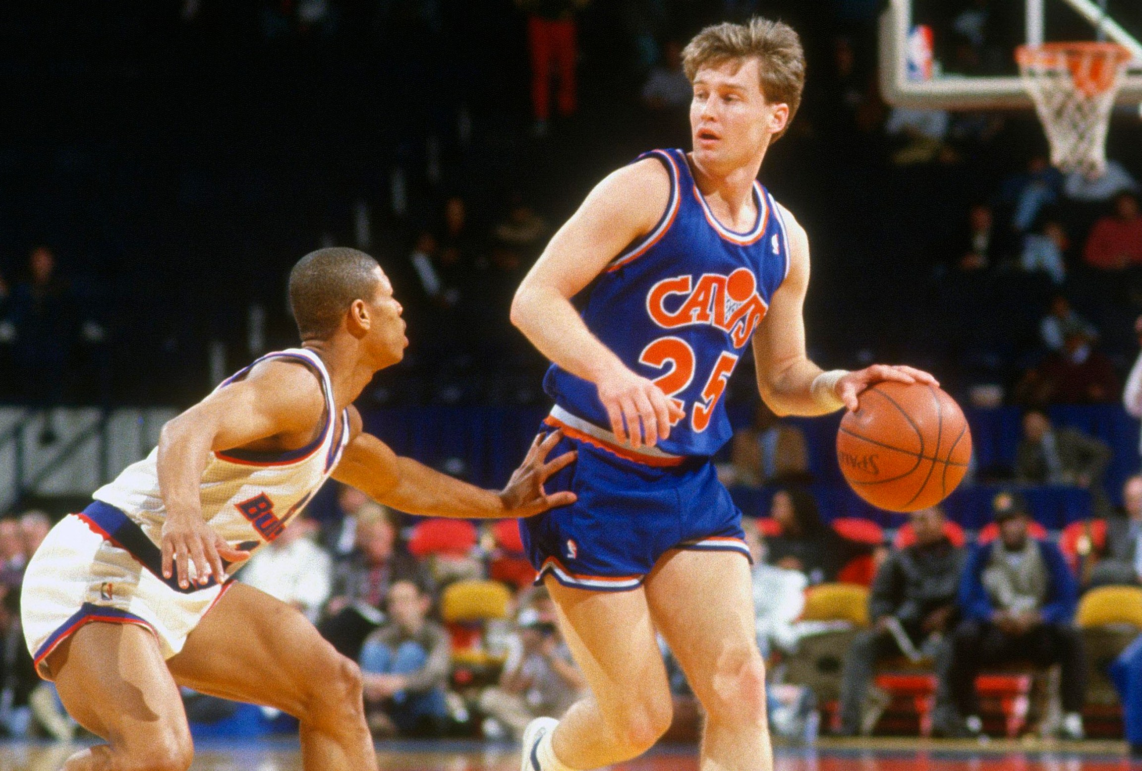 LANDOVER, MD - CIRCA 1987: Mark Price #25 of the Cleveland Cavaliers dribbles the ball while defended by Muggsy Bogues #1 of the Washington Bullets during an NBA basketball game circa 1987 at the Capital Centre in Landover, Maryland. Price played for the Cavaliers from 1986-95. (Photo by Focus on Sport/Getty Images)