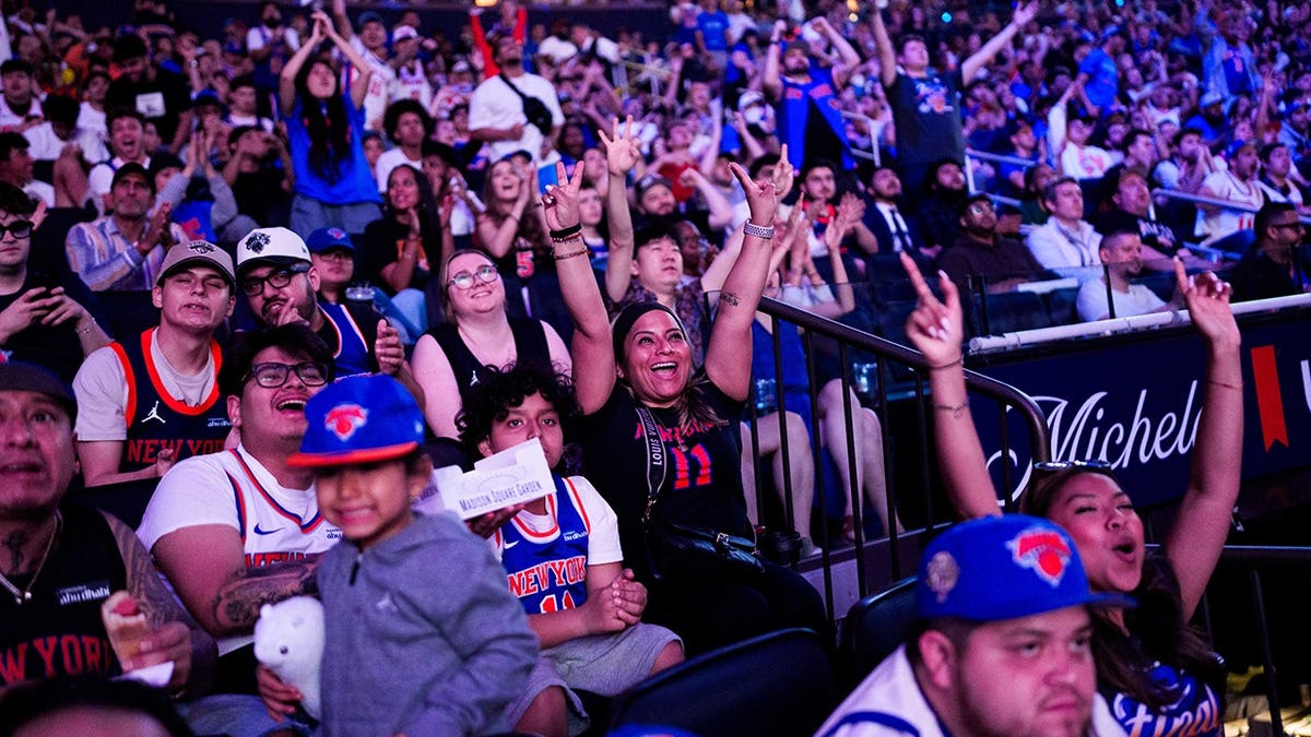 Fans reacting at a watch party inside Madison Square Garden in New York City