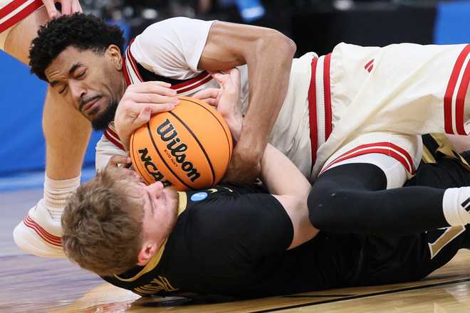 Jamarques Lawrence,Tyler Nickel Nebraska guard Jamarques Lawrence, top, and Vanderbilt forward Tyler Nickel, bottom, try to control the ball during the first half in the second round of the NCAA college basketball tournament, Saturday, March 21, 2026, in Oklahoma City.