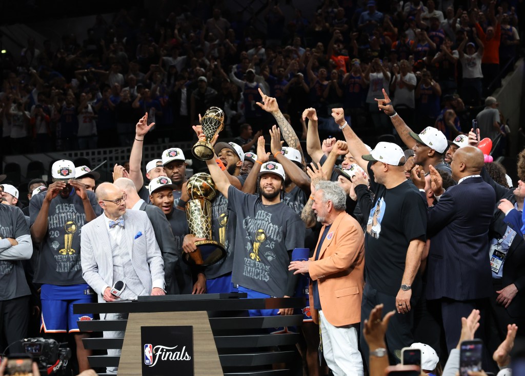 Jalen Brunson lifts the NBA Finals MVP trophy after the Knicks' championship win on June 13, 2026.