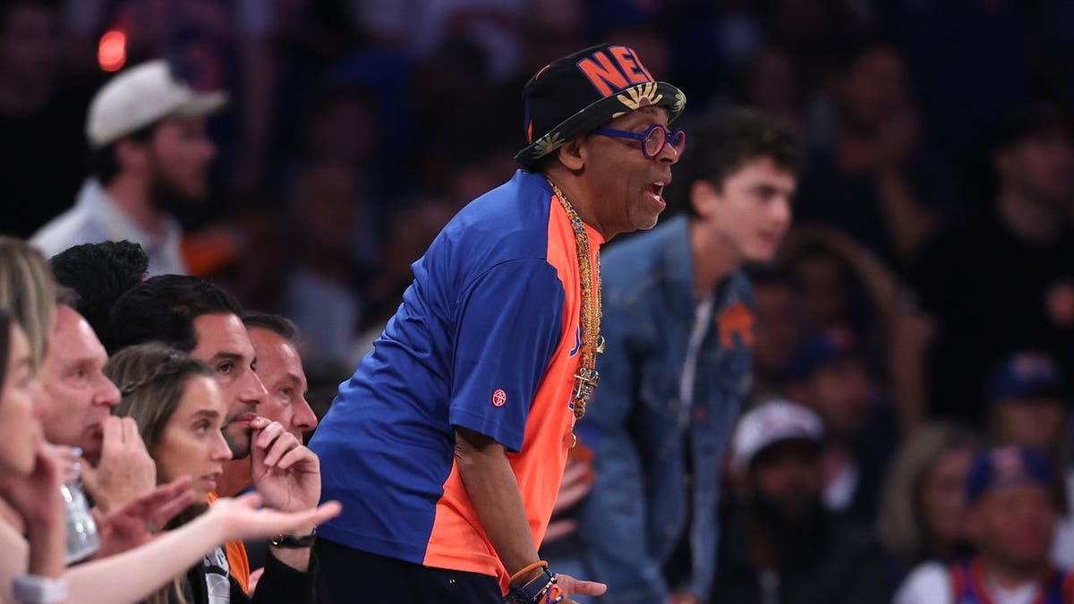 Spike Lee standing courtside at Madison Square Garden during the NBA Finals game.