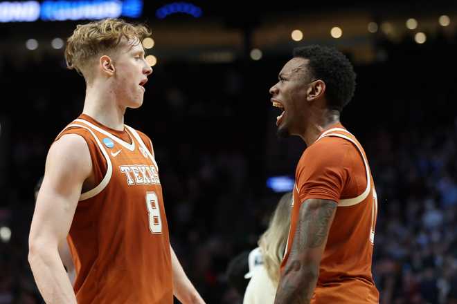 Texas Texas center Matas Vokietaitis (8) celebrates with forward Nic Codie after the second round of the NCAA college basketball tournament against Gonzaga, Saturday, March 21, 2026, in Portland, Ore.