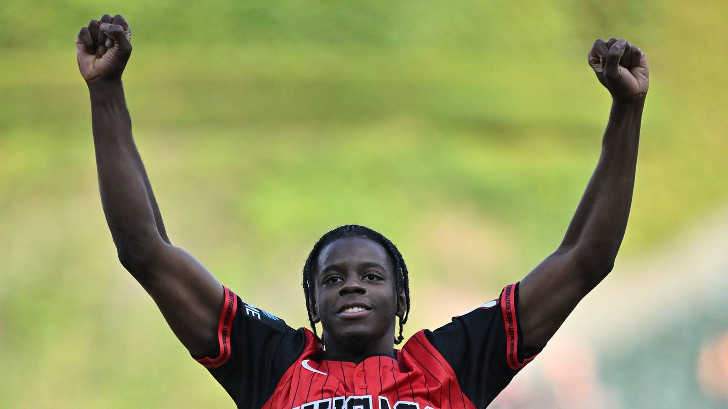Jul 7, 2026; Chicago, Illinois, USA; Chicago Bulls 2026 NBA Draft first round pick Caleb Wilson reacts after throwing out a ceremonial first pitch prior to a game between the Chicago White Sox and the Boston Red Sox at Rate Field. Mandatory Credit: Patrick Gorski-Imagn Images