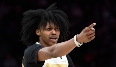 Dec 23, 2025; Charlotte, North Carolina, USA;  Washington Wizards guard Bub Carrington (7) reacts to a foul call during the first half against the Charlotte Hornets at the Spectrum Center. Mandatory Credit: Sam Sharpe-Imagn Images