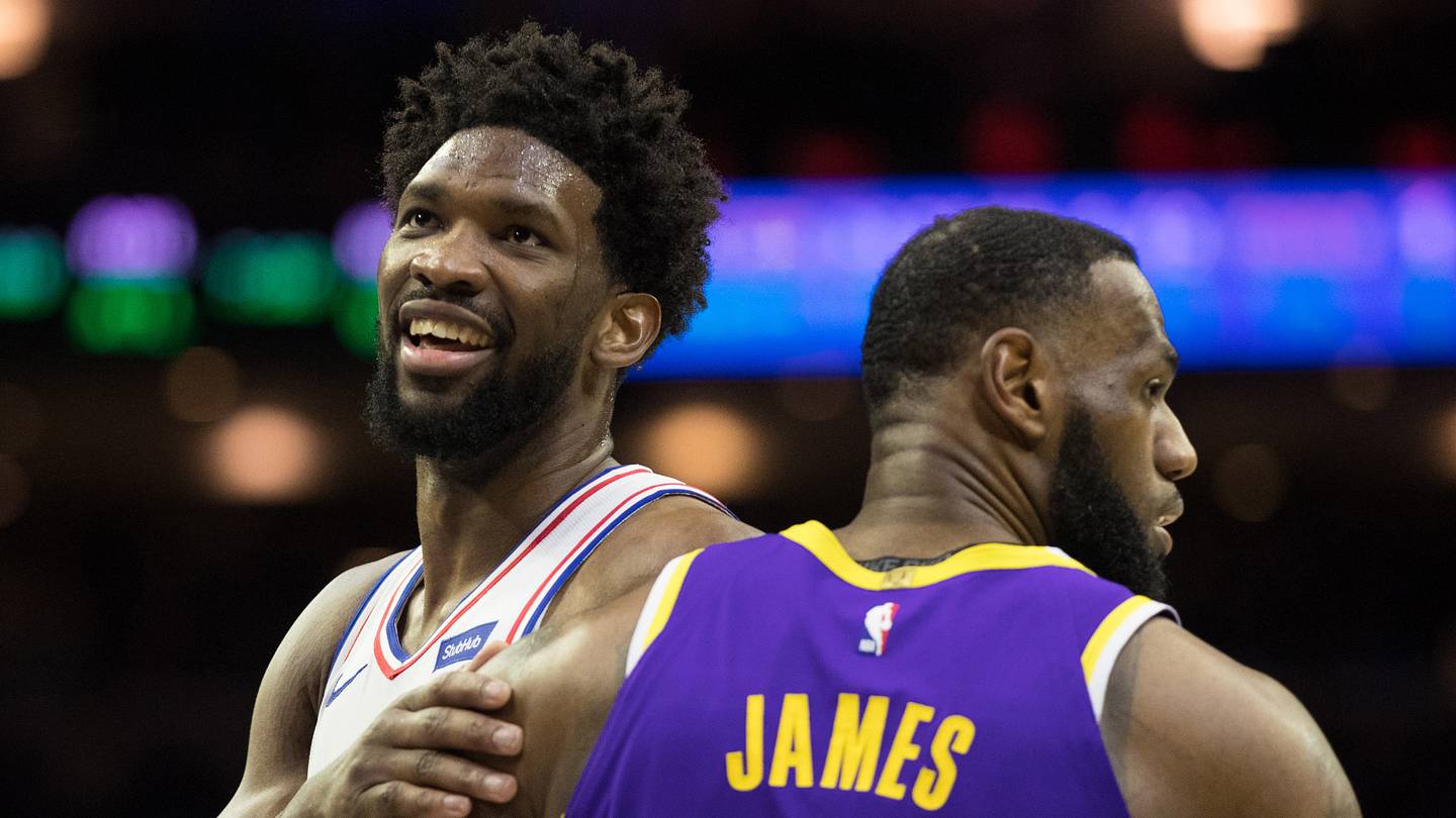 Philadelphia 76ers center Joel Embiid (21) reacts with Los Angeles Lakers forward LeBron James (23) after a 76ers score during the fourth quarter at Wells Fargo Center.