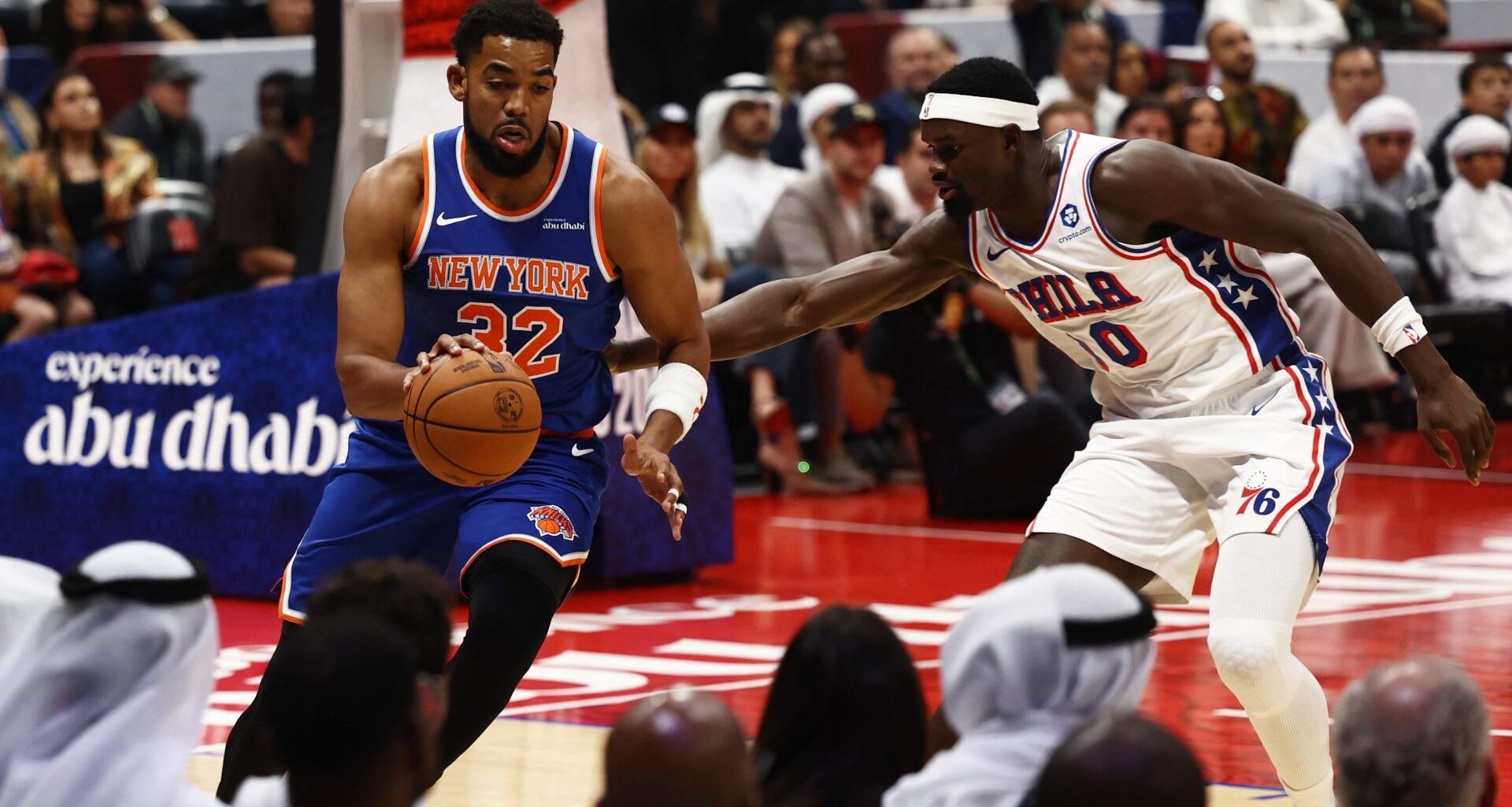 Basketball - NBA - New York Knicks v Philadelphia 76ers - Etihad Arena, Abu Dhabi, United Arab Emirates - October 4, 2025 New York Knicks' Karl-Anthony Towns in action with Philadelphia 76ers' Adem Bona