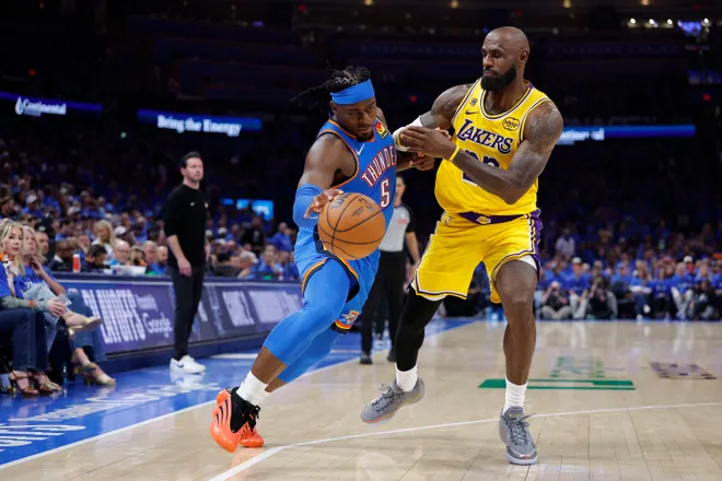 May 5, 2026; Oklahoma City, Oklahoma, USA; Oklahoma City Thunder guard Luguentz Dort (5) drives around Los Angeles Lakers forward LeBron James (23) in the second half during game one of the second round of the 2026 NBA Playoffs at Paycom Center. Mandatory Credit: Alonzo Adams-Imagn Images