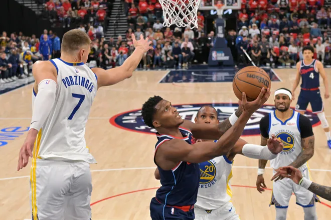 Apr 15, 2026; Inglewood, California, USA; Los Angeles Clippers guard Bennedict Mathurin (9) gets past Golden State Warriors center Kristaps Porzingis (7) and center Al Horford (20) for a basket in the first half during the play-in rounds of the 2026 NBA Playoffs at Intuit Dome. Mandatory Credit: Jayne Kamin-Oncea-Imagn Images