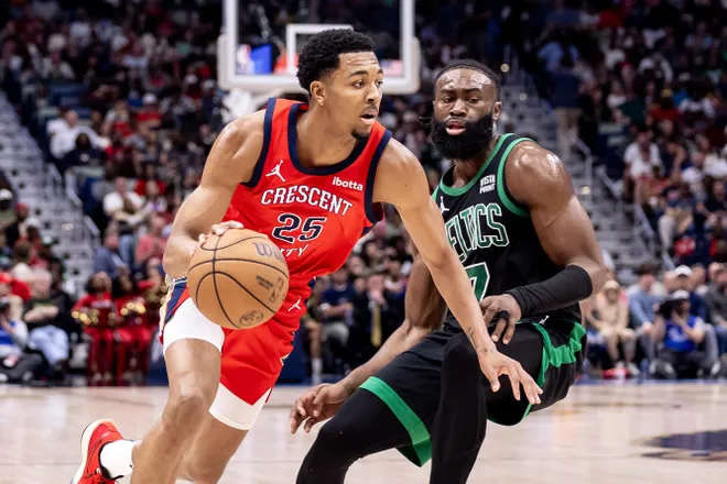 Mar 30, 2024; New Orleans, Louisiana, USA; New Orleans Pelicans guard Trey Murphy III (25) dribbles against Boston Celtics guard Jaylen Brown (7) during the second half at Smoothie King Center. Mandatory Credit: Stephen Lew-USA TODAY Sports