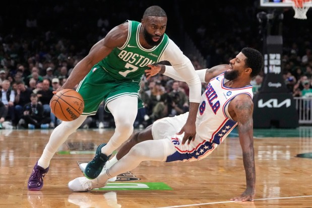 Boston Celtics guard Jaylen Brown, left, drives to the basket against the 76ers' Paul George during Game 2 of a first-round NBA playoff series on April 21, 2026, in Boston. (AP Photo/Charles Krupa)