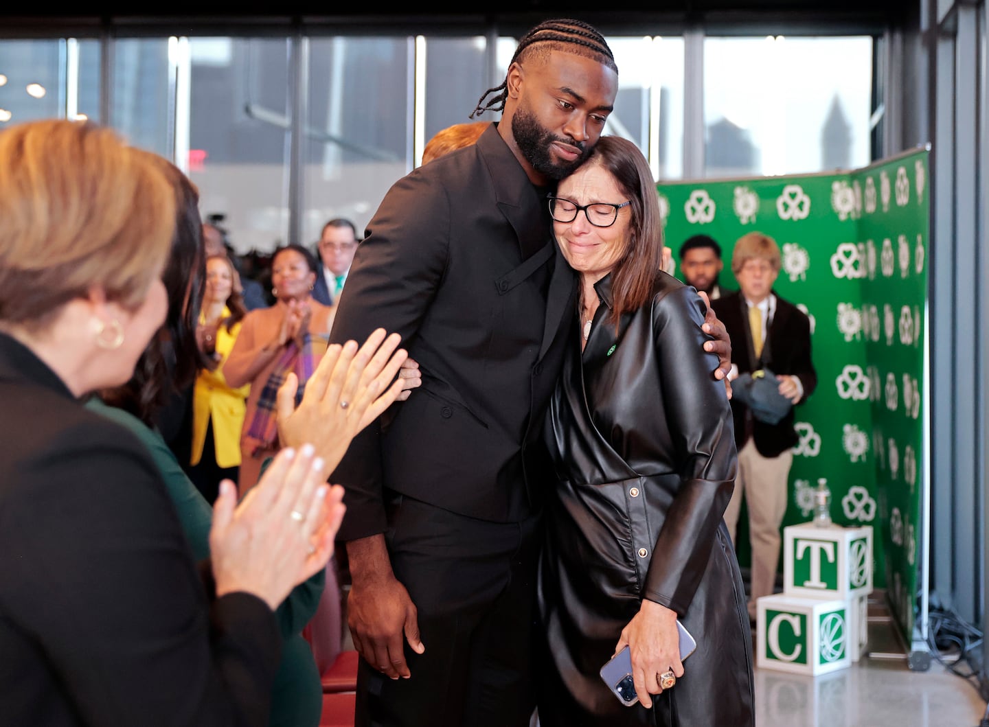 Jaylen Brown embraces Jeannine Russell after she gave tearful remarks about her late husband after a news conference to rename the North Washington Street Bridge to the William Felton “Bill” Russell Bridge in 2024.