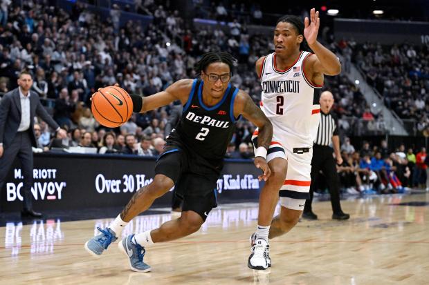 DePaul Blue guard Layden Blocker (2) is guarded by UConn guard Silas Demary Jr. (2) in the first half of an NCAA college basketball game, Saturday, Jan. 10, 2026, in Hartford, Conn. (AP Photo/Jessica Hill)