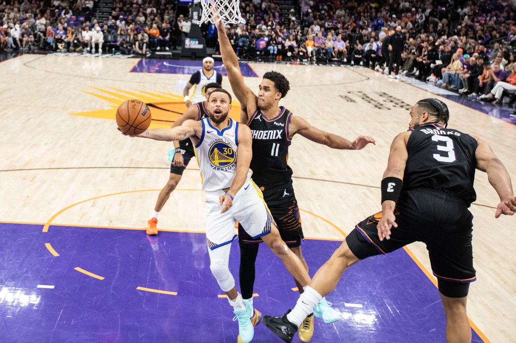 Stephen Curry of the Golden State Warriors driving to the basket.
