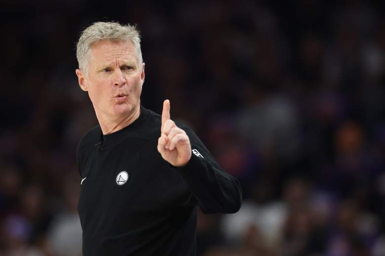 Golden State Warriors coach Steve Kerr raises one finger while directing his team from the sideline.