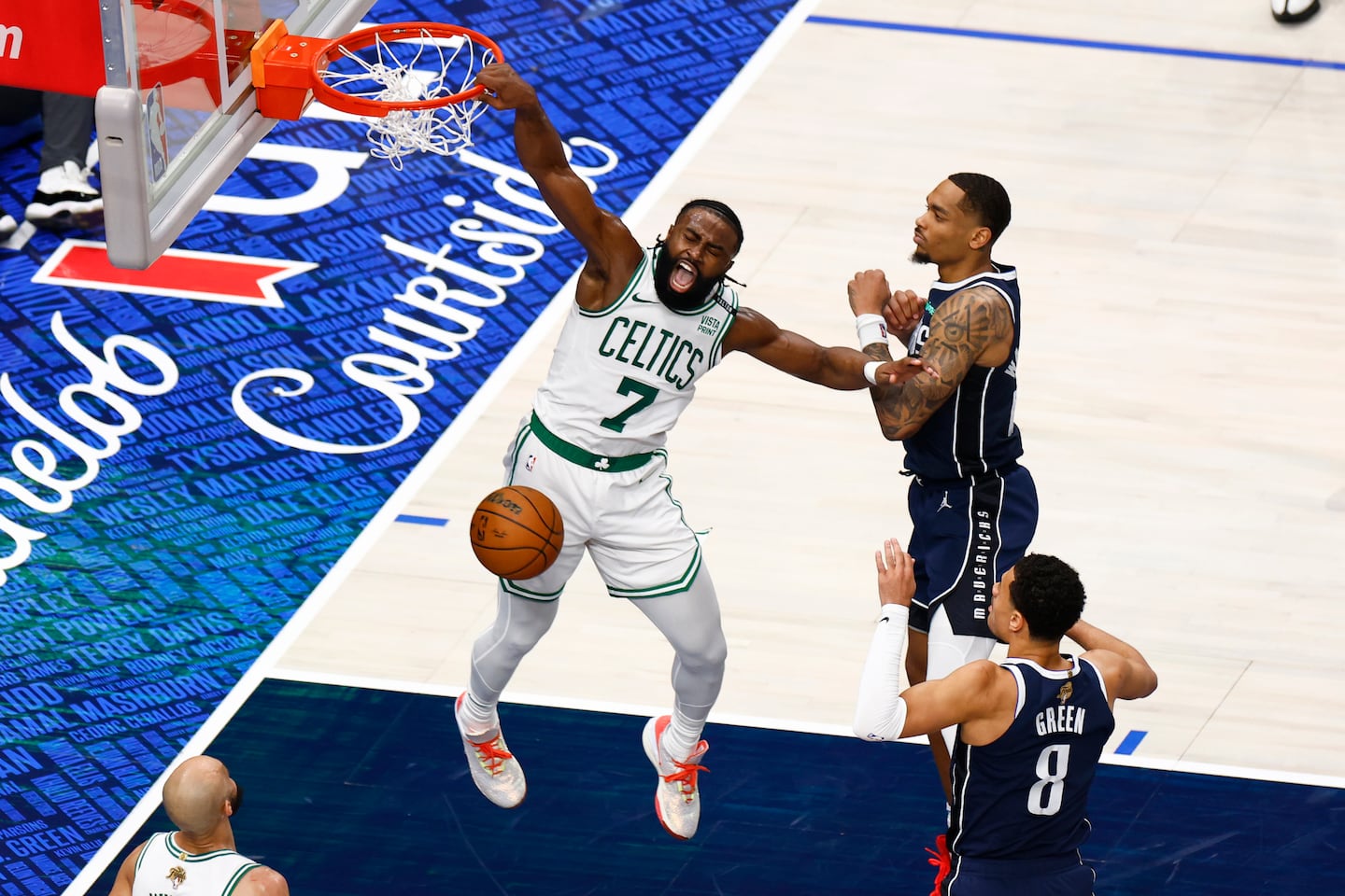 Jaylen Brown dunks against Mavericks forward P.J. Washington during Game 3 of the NBA Finals in 2024.