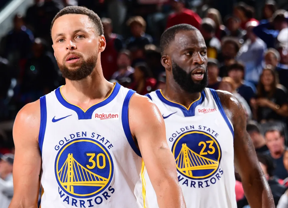 Stephen Curry #30 and Draymond Green #23 of the Golden State Warriors look on during the game against the LA Clippers