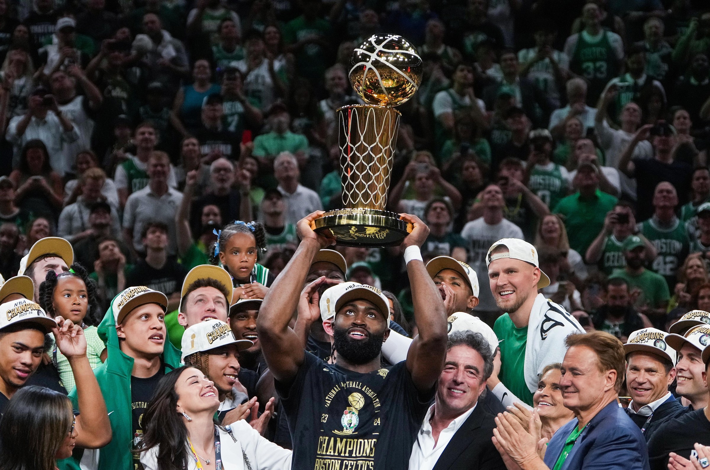 Boston, MA - June 17: Boston Celtics guard Jaylen Brown hoists the Larry O’Brien Championship trophy at the end of Game 5 of the 2024 NBA Finals. (Photo by Barry Chin/The Boston Globe via Getty Images)