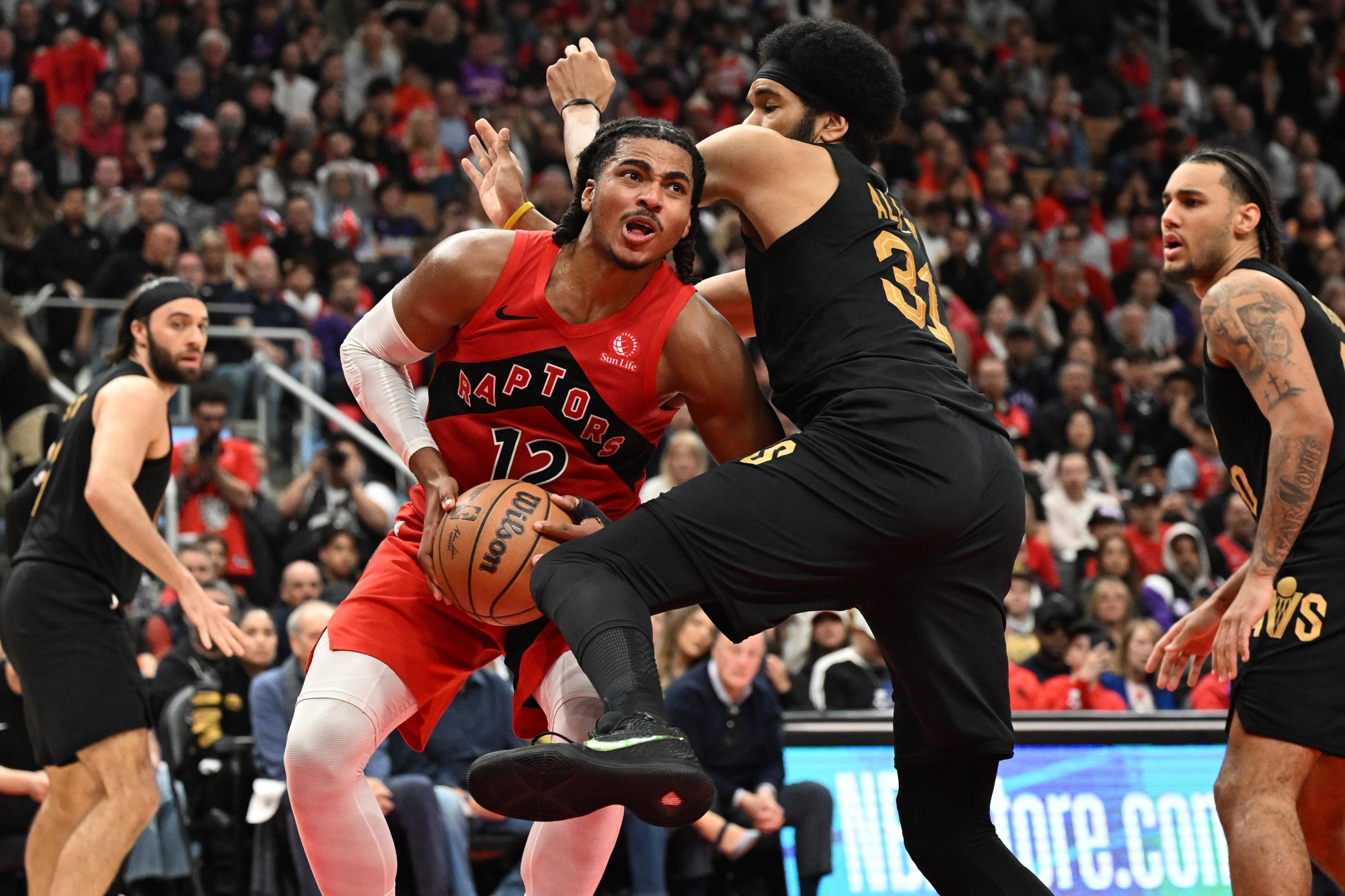 Apr 26, 2026; Toronto, Ontario, CAN; Toronto Raptors forward Collin Murray-Boyles (12) tries to get to the basket against Cleveland Cavaliers center Jarrett Allen (31) game four of the first round of the 2026 NBA Playoffs at Scotiabank Arena. Mandatory Credit: Dan Hamilton-Imagn Images