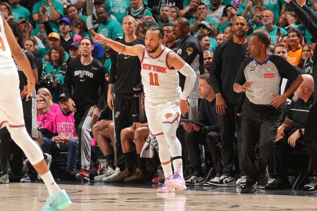 New York Knicks player Jalen Brunson, wearing jersey #11, points during the 2026 NBA Finals game against the San Antonio Spurs.